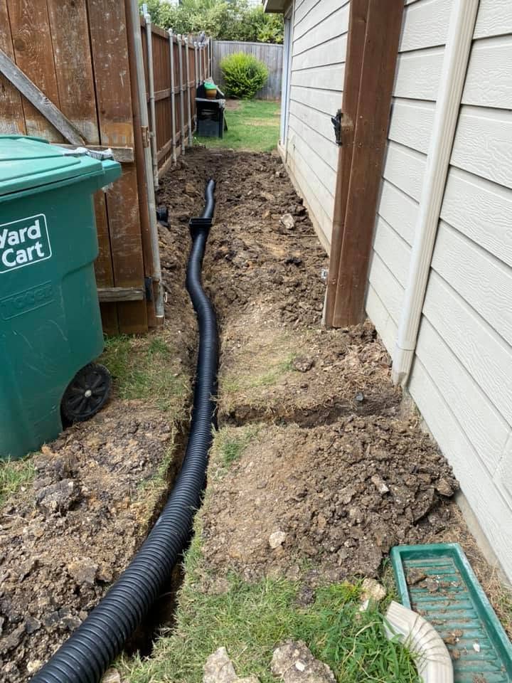 Drainage pipe being installed beside a residential home