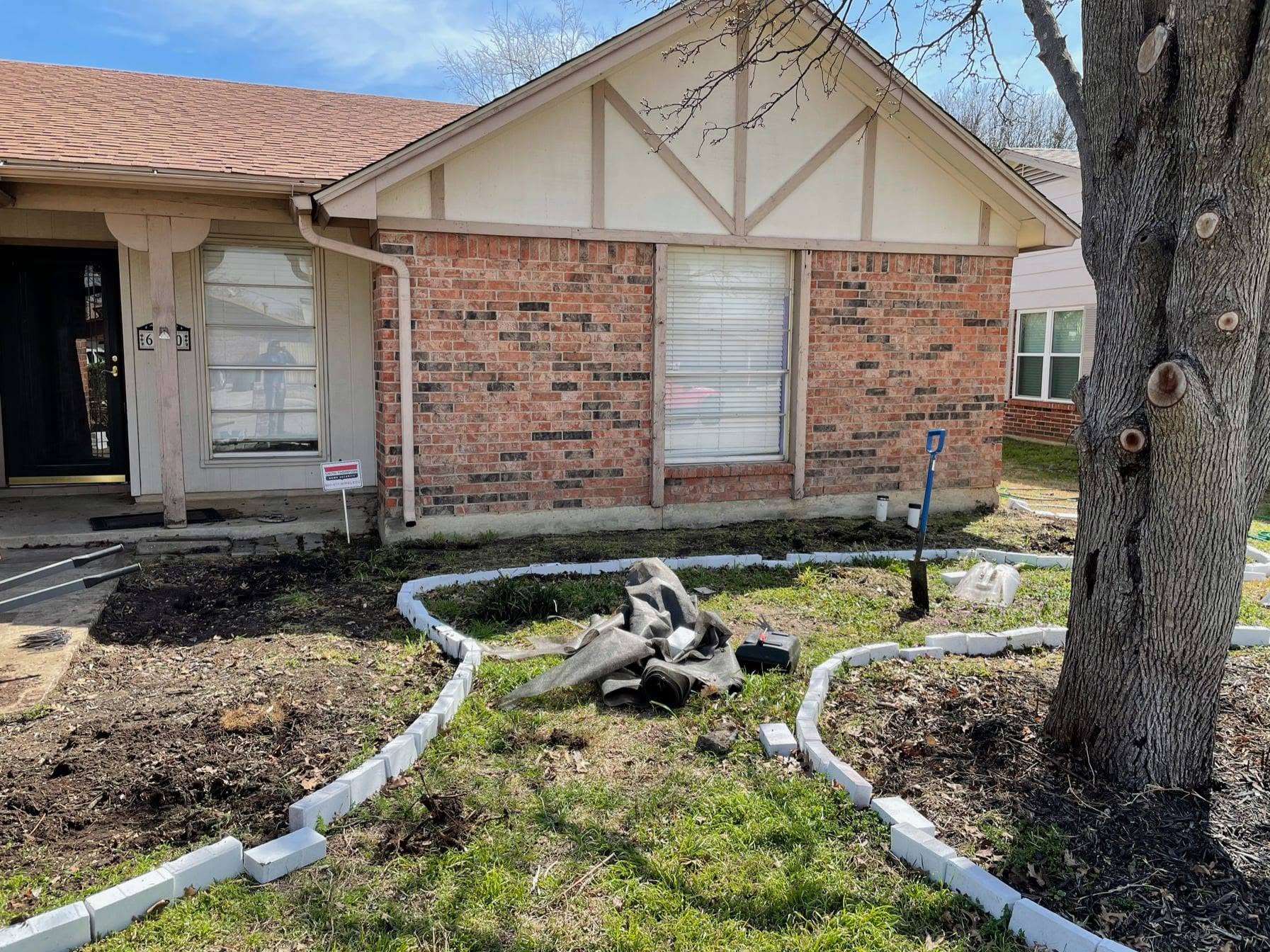 Front yard with stone bed edging being laid out before mulching